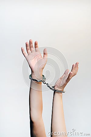 Criminal hands locked in handcuffs Stock Photo