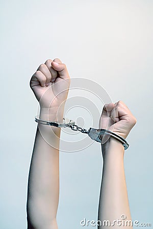 Criminal hands locked in handcuffs Stock Photo