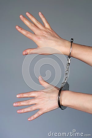 Criminal hands locked in handcuffs Stock Photo