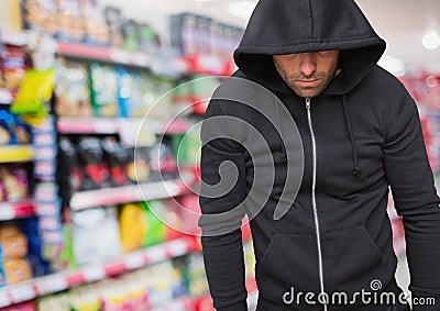 Criminal in hood in shop store Stock Photo