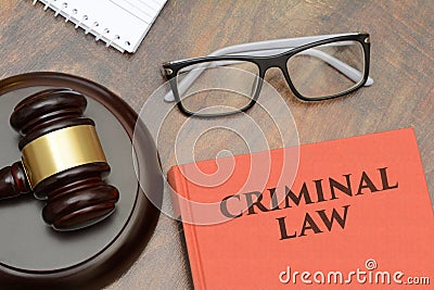 Criminal Law sign with wooden gavel and red book Stock Photo