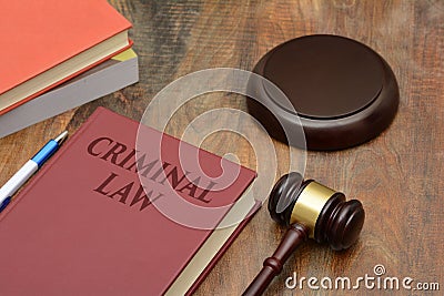 Criminal Law sign with wooden gavel and red book Stock Photo