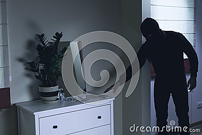 Criminal robbing luxurious mansion Stock Photo