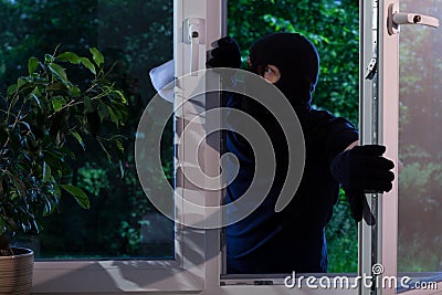 Criminal robs the house Stock Photo