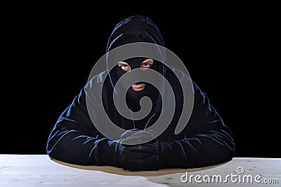 Criminal or terrorist man in mask hidden identity in secret illegal activity crime concept Stock Photo