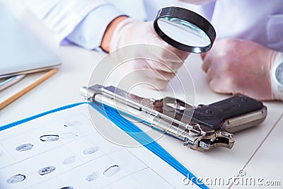 The criminologist police chemist looking at crime evidence Stock Photo