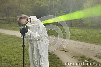 Measuring of bullet trajectory with ballistics trajectory laser and smoke on crime scene Stock Photo