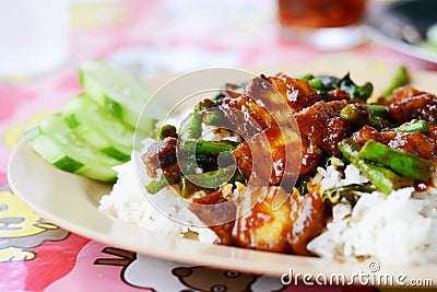 Cripy pork with red curry on top rice Stock Photo