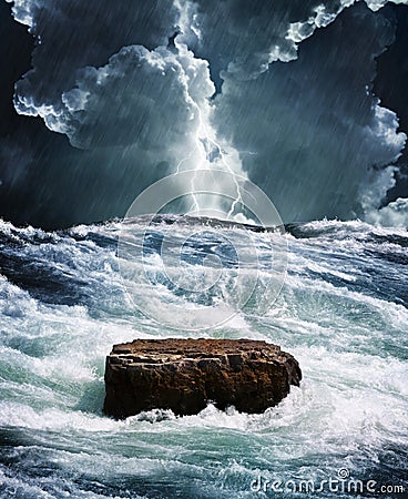 Crisis rock in raging ocean Stock Photo