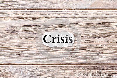 CRISIS of the word on paper. concept. Words of CRISIS on a wooden background Stock Photo