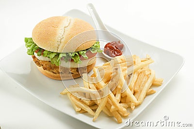 Crisp chicken burger tomato onion cheese lettuce Stock Photo
