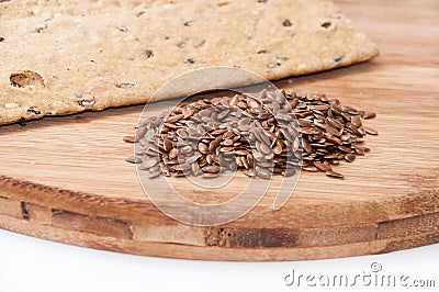 Crisp diet plates made of linen and linen seeds on the wooden bo Stock Photo