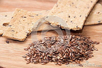 Crisp diet plates made of linen and linen seeds on the wooden bo Stock Photo