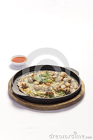 Crisp fried oyster pancake in hot plate Stock Photo