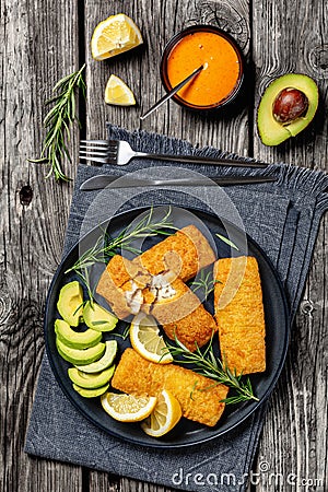 crispy baked battered pollock fillet on a plate Stock Photo