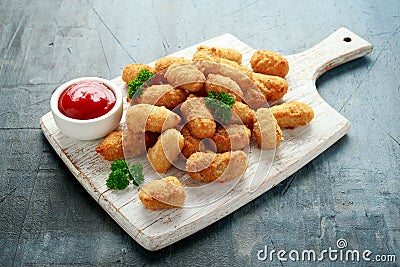 Crispy Battered scampi nuggets with ketchup on white wooden board Stock Photo