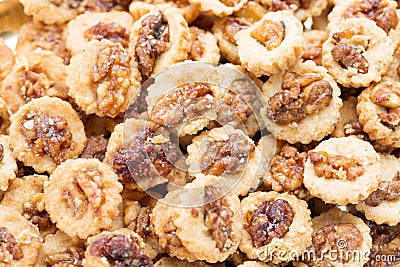 Crispy cookies with walnuts as a background close up. Selective focus Stock Photo