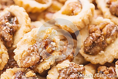 Crispy cookies with walnuts as a background close up. Selective focus Stock Photo