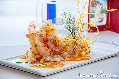 Crispy deep fried tiger prawn with mango salsa and thousand island sauce Stock Photo