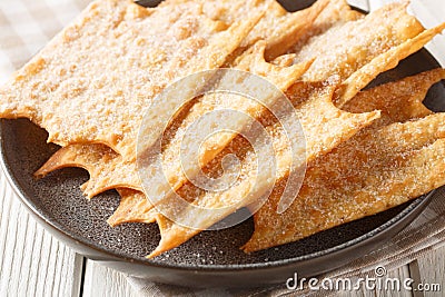 Crispy French holiday fritters Oreillette close-up in a plate. horizontal Stock Photo