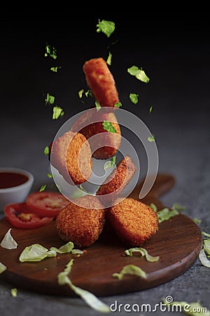 Crispy fried chicken nuggets with Ketchup on wooden board.flying chicken nuggets Stock Photo