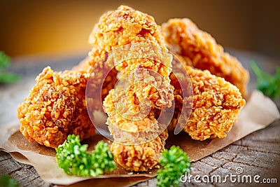 Crispy fried chicken wings on wooden table Stock Photo