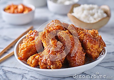 Crispy fried korean chicken wings in soy garlic sauce with pickled radish and kimchi sides Stock Photo