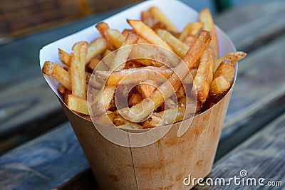 Crispy golden french fries in paper cone Stock Photo