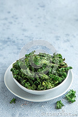 Crispy kale chips in bowl, healthy vegan food Stock Photo