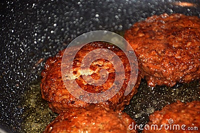 Crispy meatballs fry in oil in a pan macro shot eat theme Stock Photo