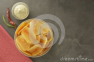 Crispy potato chips with delicious sauce. Top view. Copy space Stock Photo