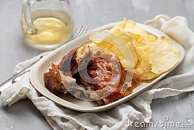 crispy tasty baked piglet and potato in ceramic dish Stock Photo