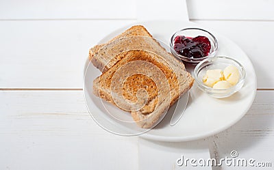Crispy toast with butter and jam. Served on a white dish Stock Photo