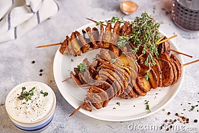 Crispy tornado potatoes. Potato chips on skewers, roasted with thyme and spices Stock Photo