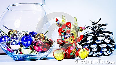 Cristmas presents. Toy bull, symbol of the year. Pine cone, multi-colored balls. Stock Photo