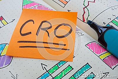 CRO Conversion Rate Optimization note in an open notebook. Stock Photo