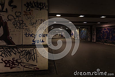 Croatia, Zagreb, June 21, the dark passage of a deserted, eerie creepy concrete indoor pathway grafted with graffiti at night Editorial Stock Photo