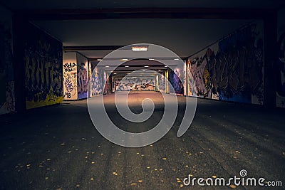 Croatia, Zagreb, June 21, the dark passage of a deserted, eerie creepy concrete indoor pathway grafted with graffiti at night Editorial Stock Photo