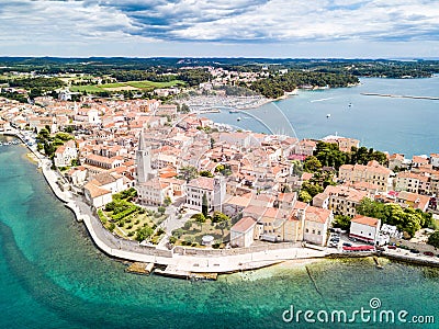 Croatian town of Porec, shore of blue azure turquoise Adriatic Sea, Istrian peninsula, Croatia. Bell tower, red tiled roofs. Stock Photo