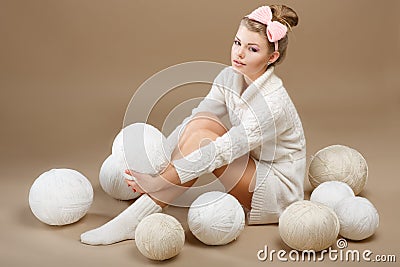 Crochet. Beautiful Needlewoman Sitting with Pile of White Skeins of Yarn. Needlecraft Stock Photo