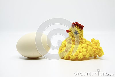 Crochet chick standing near an real egg Stock Photo