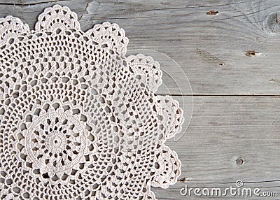 Crochet doily over old grey wood Stock Photo