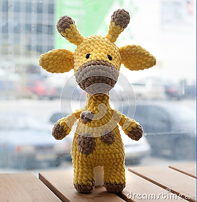 Crocheted amigurumi yellow giraffe. Knitted handmade toy Stock Photo