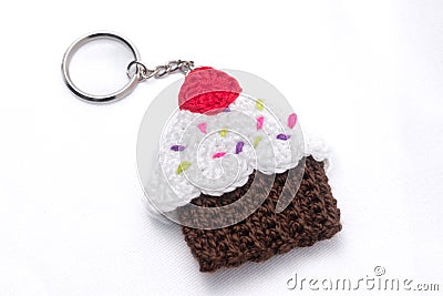 Crocheted keychain in the shape of a vanilla and raspberry cupcake Stock Photo