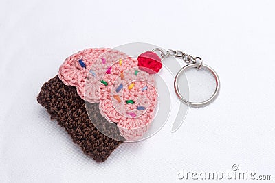 Crocheted keychain in the shape of a vanilla and raspberry cupcake Stock Photo
