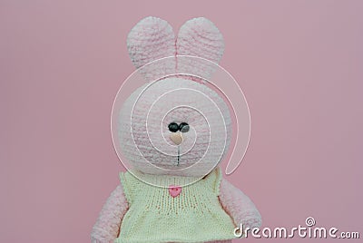 Crocheted plush pink bunny. Soft toy knitted bunny Stock Photo