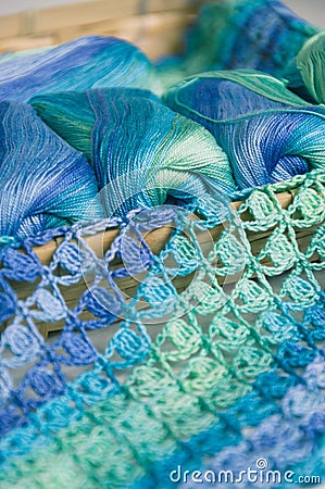 Crocheting in blue and green tones and skeins piled together Stock Photo