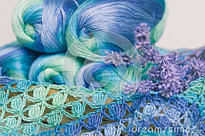 Crocheting in blue and green tones and skeins piled together Stock Photo