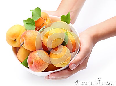 Crockery with mellow apricots. Stock Photo