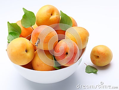 Crockery with mellow apricots. Stock Photo